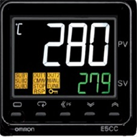 An industrial digital controller displaying temperature values.